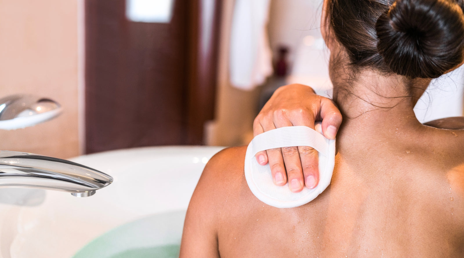 Woman Removing Tan in Bath